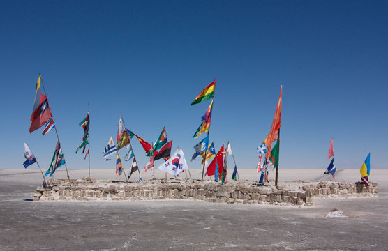 flags of the different countries on the saline land Salar de Uyuni in Bolivia