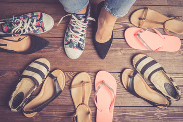 Collection of female shoes on wooden floor. Fashion background - 142137347