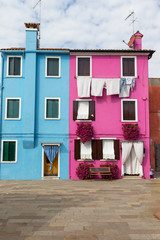 Blue and pink houses in the island named Burano (Venice, Italy). All potential trademarks are removed.