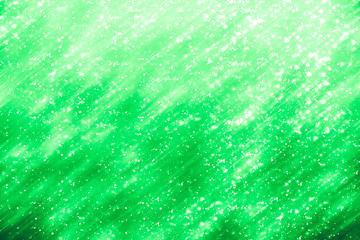Green abstract background. Bokeh or round defocused particles or glitter lights