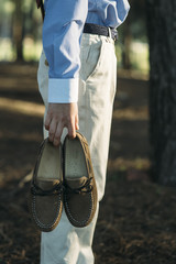 Elegant child with shoes in the hand