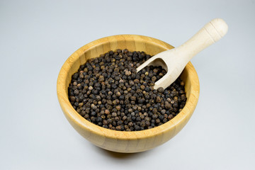 A bowl of black pepper grains