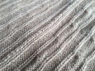 Close-up photo of knitted crumpled textured surface background