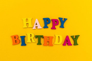 The inscription "Happy Birthday" in colorful letters on a yellow background.