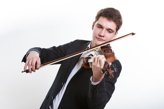 Man man dressed elegantly playing violin