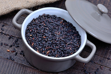 Black rice in a pot on table