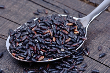 Black rice in a silver spoon