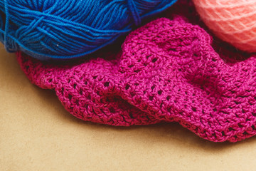 Hanks of bright yarn for knitting on a bright background