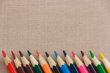 Colour pencils on wooden texture background