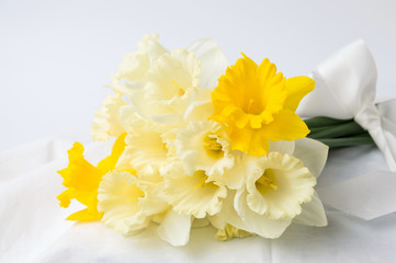 Narcissus flowers bouquet wrapped in textile