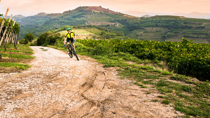 Fototapeta premium Cyclist pedaling through the hills.