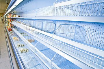 Refrigerated counter. Empty counters. Retail store equipment. © Grispb