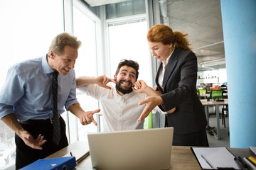 Angry bosses man and woman screaming, shouting and yelling at their worker. Handsome man having stress and closing with ears. Mobbing, stress, work, scandal concepts.