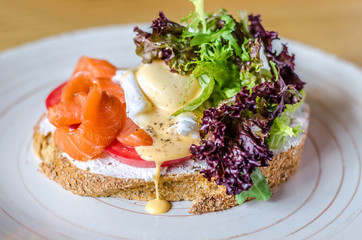 Sandwich with red fish cheese and herbs