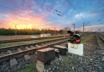 Railway station with semaphore and beautiful bright cloudy sky at sunset. Colorful industrial...