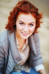 A wonderful portrait of a young pretty girl with beautiful eyes and charming smile, outdoor, closeup.