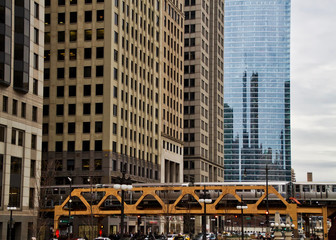 Transit system in Chicago - The Elevated "el" train crosses Wacker Drive on the Wells Street bridge during evening commute.