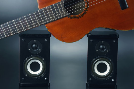 two stereo audio speakers and classical acoustic guitar