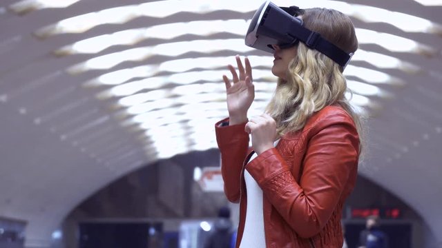 woman uses a virtual reality glasses on abstract background