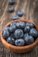Deluxe blackberries in bowl on wooden background. Close up, top view