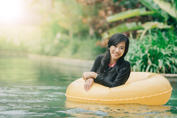 young woman enjoying tubing at lazy river pool