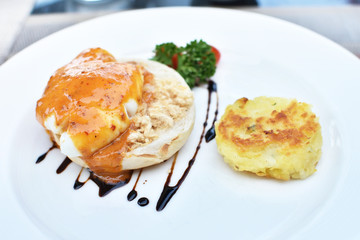 Delicious eggs benedict with shreded pork