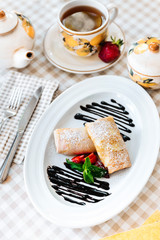 Pancakes with chocolate, fresh strawberry and mint