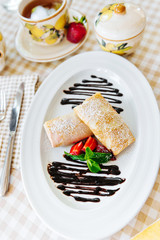 Pancakes with chocolate, fresh strawberry and mint