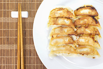 Japanese Gyoza , dumplings filled with ground meat and vegetables and wrapped in a thin dough
