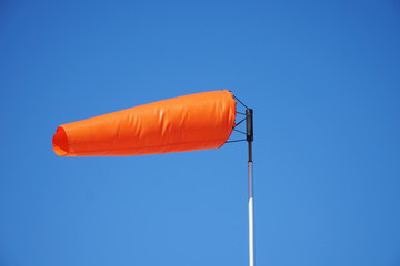 close up on orange windsock in the wind
