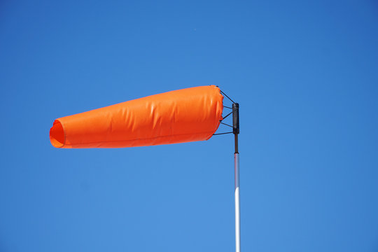 close up on orange windsock in the wind