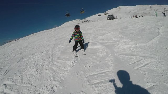Little boy skiing. Slowmotion
Little boy enjoying skiing. Child learning to ski.