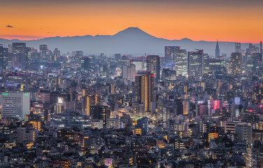 Tokyo night city view with Mountain Fuji. Mount Fuji lies about 100 kilometres south-west of Tokyo,...