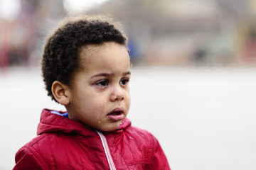 Portrait of a little upset toddler boy crying.