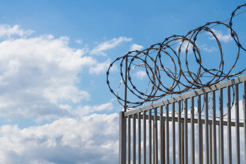 Razor wire over fence
