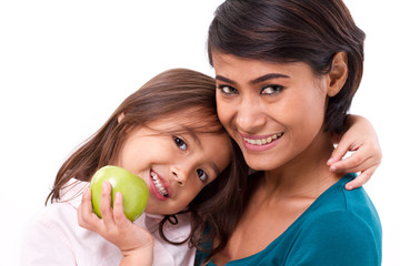 Fototapeta premium happy family, mother and daughter with raw organic green apple, concept of healthy food