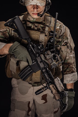 Portrait soldier or private military contractor holding sniper rifle. war, army, weapon, technology and people concept. Image on a black background.