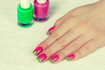 Obraz na płótnie Canvas Beautiful female hand with bicolor green pink. Manicure salon