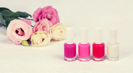 Fototapeta na wymiar Nail polish for french manicure decorated with rose flowers.