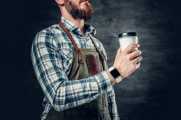Close up image of a man holds a cup of coffee.