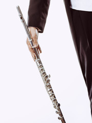 Male flutist wearing tailcoat holds flute
