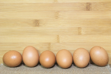 Egg on wooden table with bamboo background