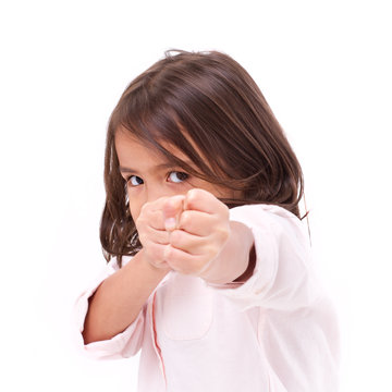 little girl assuming stance, practicing martial arts, self-defense, kungfu, karate, boxing