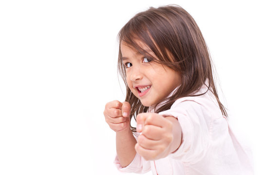little girl assuming stance, practicing martial arts, self-defense, kungfu, karate, boxing