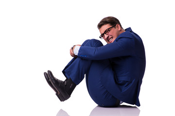 Businessman sitting on the floor isolated on white