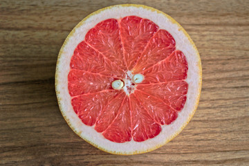 Fototapeta na wymiar Closeup of a grapefruit half on a wooden table