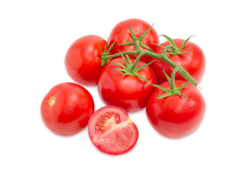 Whole, half and branch of the ripe red tomatoes closeup