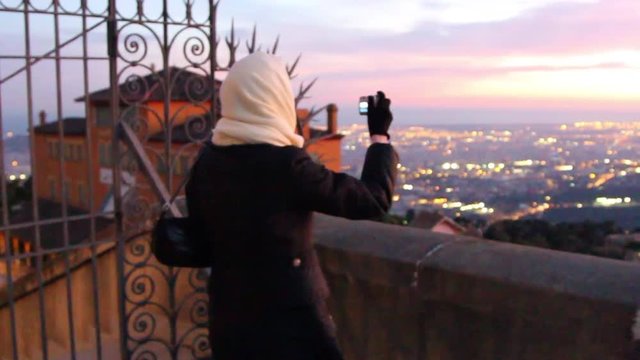 Woman is taking photo of Magnificent Sunset at Tibidabo mountain in Barcelona, spain hd video