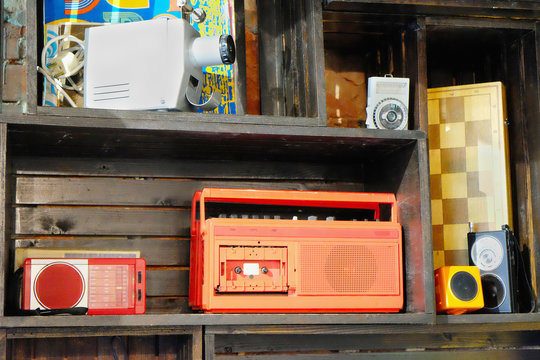 vintage items on the shelf. radio, chess, photoprojector