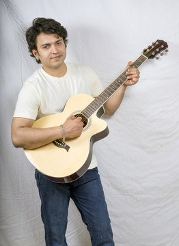 indian male model playing guitar